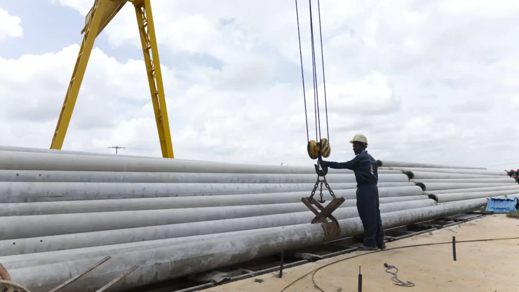 Massive outdoor stockyard with TANESCO-compliant spun concrete poles.