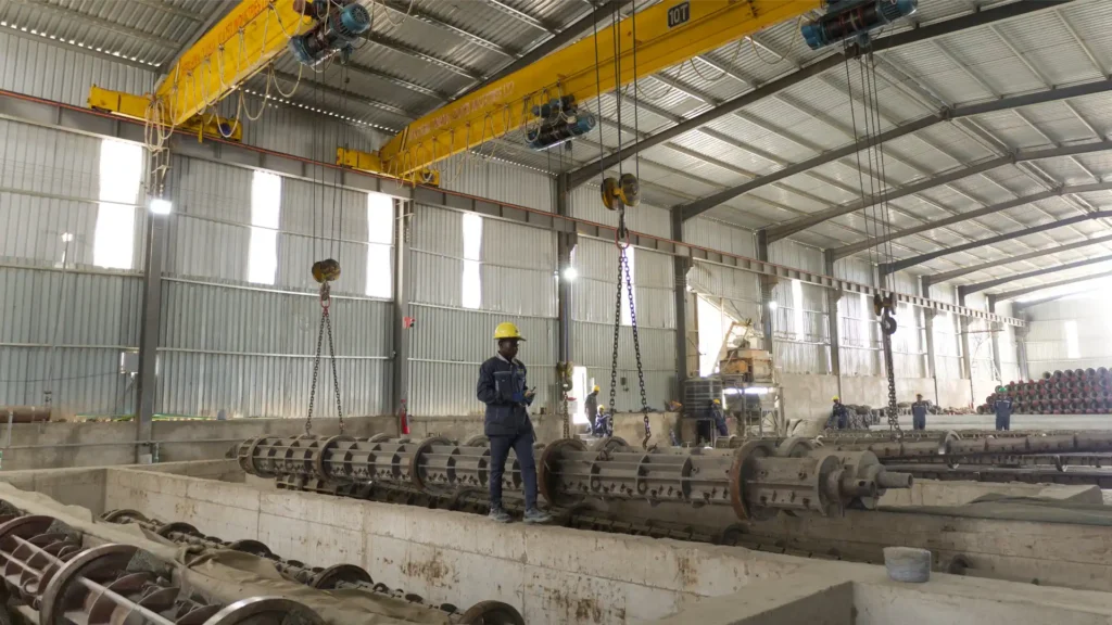 Advanced centrifugal spinning machinery for zero-porosity concrete poles.