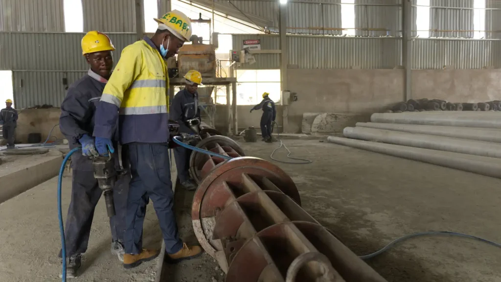 Heavy-duty steel molds preparation line for concrete electrical poles manufacturing.