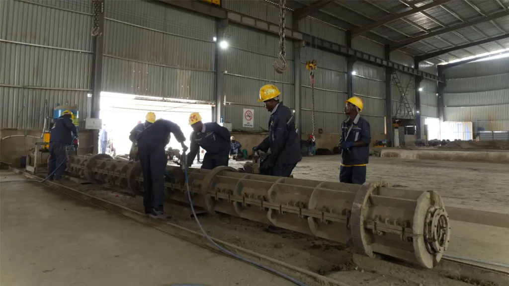 Heavy-duty steel molds preparation line for concrete electrical poles manufacturing.